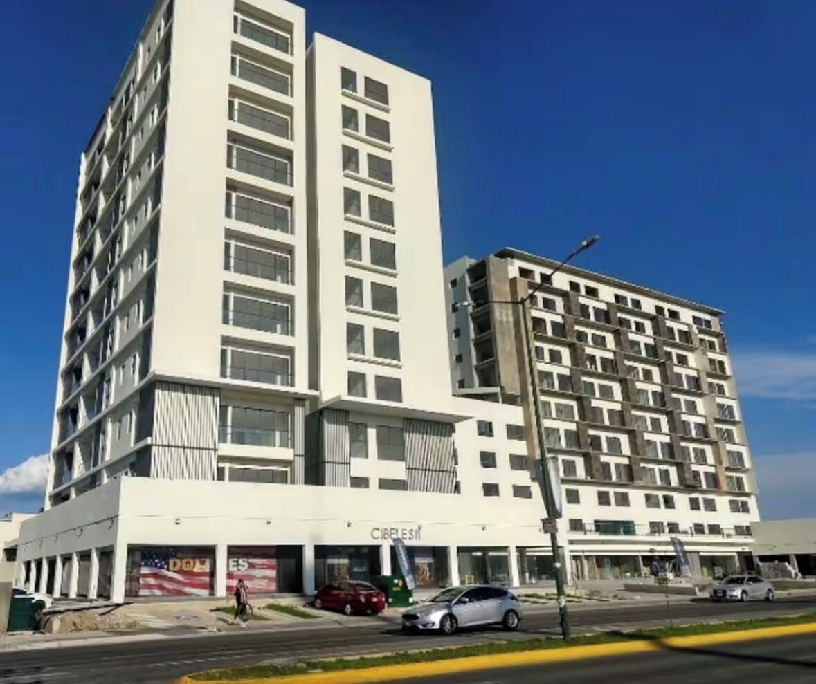 A multi-story hotel with a modern design, featuring a prominent 'CIBELES' sign on the ground floor.