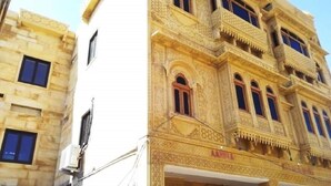A multi-story building with intricate architectural details, including arched windows and decorative patterns.