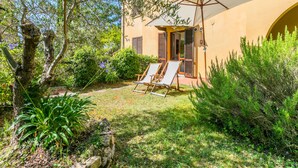 A villa with a garden, outdoor seating, and a covered patio. - Il Castello by Interhome (Montescudaio)