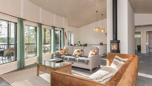 A spacious living room with a sofa, a coffee table, and a fireplace.