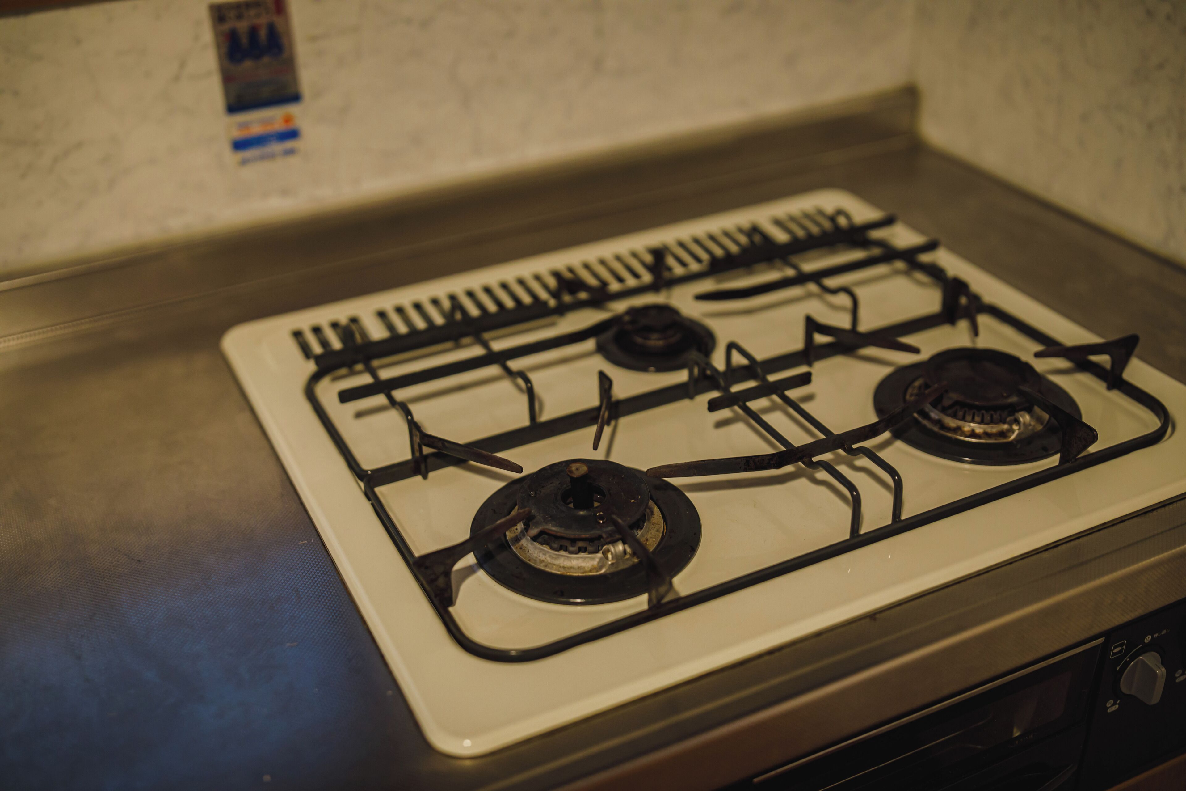 A kitchen with a gas stove, oven, and a microwave.