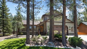 A two-story house with a front entrance, large windows, and a well-maintained lawn. - Stony Creek Cabin (Big Bear Lake)