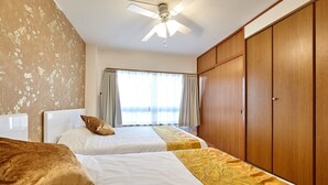 A hotel room with two beds, a ceiling fan, a large wardrobe, and a window with curtains. - XS01 XROSS STAY Namba1 (大阪市)