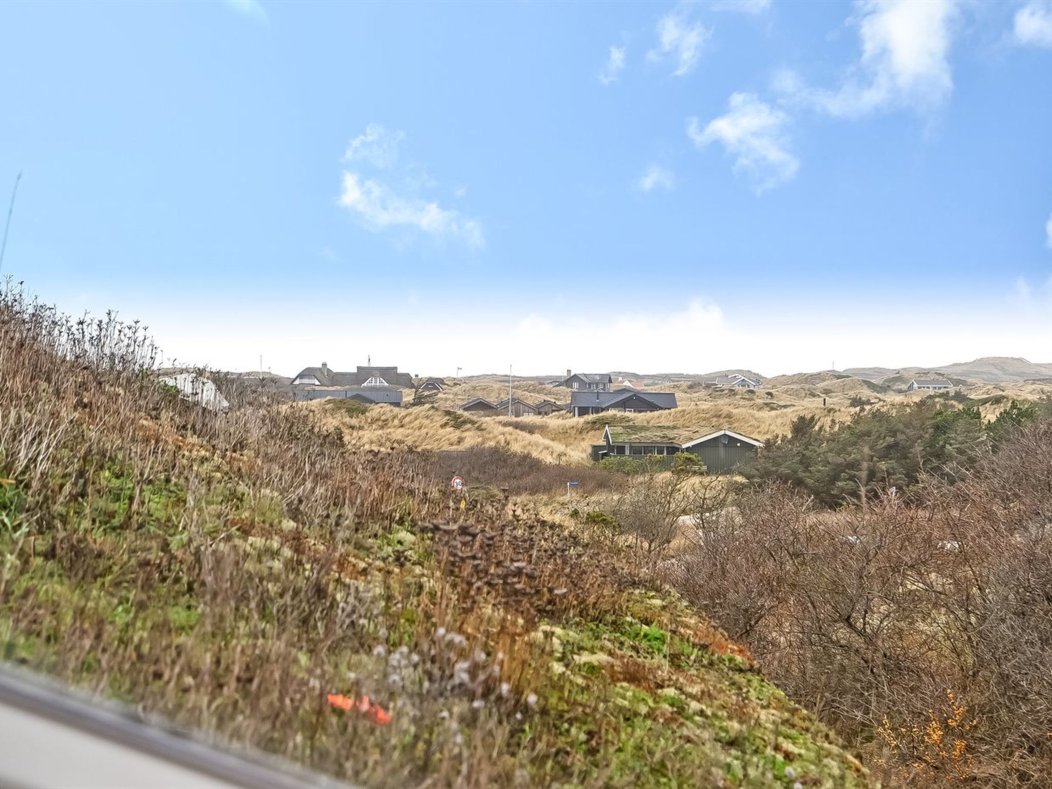 A rural landscape with houses and a road.