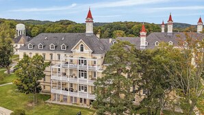 A large, historic building with multiple towers and a central courtyard. - 2BR Penthouse w/ Balcony | Grand Traverse Commons (Traverse City)