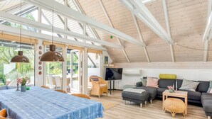 A spacious loft with a high ceiling, a dining area with a blue tablecloth, a sofa set, and a television. - "Frodde" - 200m from the sea by Interhome (Sydals)