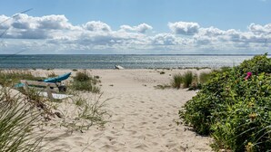 A sandy beach with a clear sky, a boat, and some greenery. - "Frodde" - 200m from the sea by Interhome (Sydals)