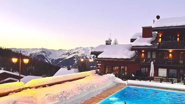 Ein Poolbereich mit verschneiter Umgebung und Bergblick.