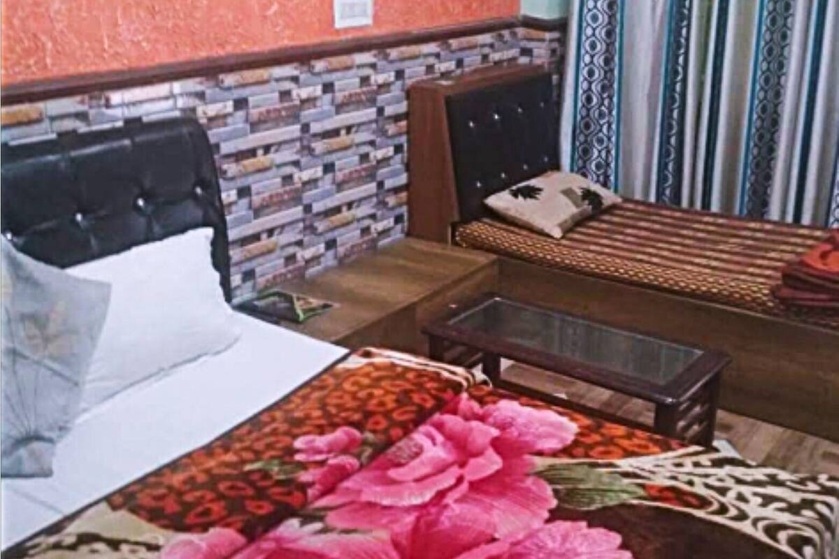A bedroom with a bed, a bedside table, and a nightstand.