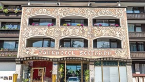 Un immeuble à plusieurs étages, doté de détails architecturaux raffinés et de balcons. L’enseigne indique : « Parkhotel Seeturni ».