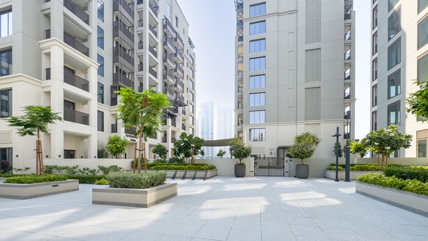 A modern residential building with multiple balconies, a spacious courtyard with planters, and a clean, contemporary design. - Creek Views 1BR, Short Drive to Ras Al Khor Sanctuary and Festival City Mall (Dubai)