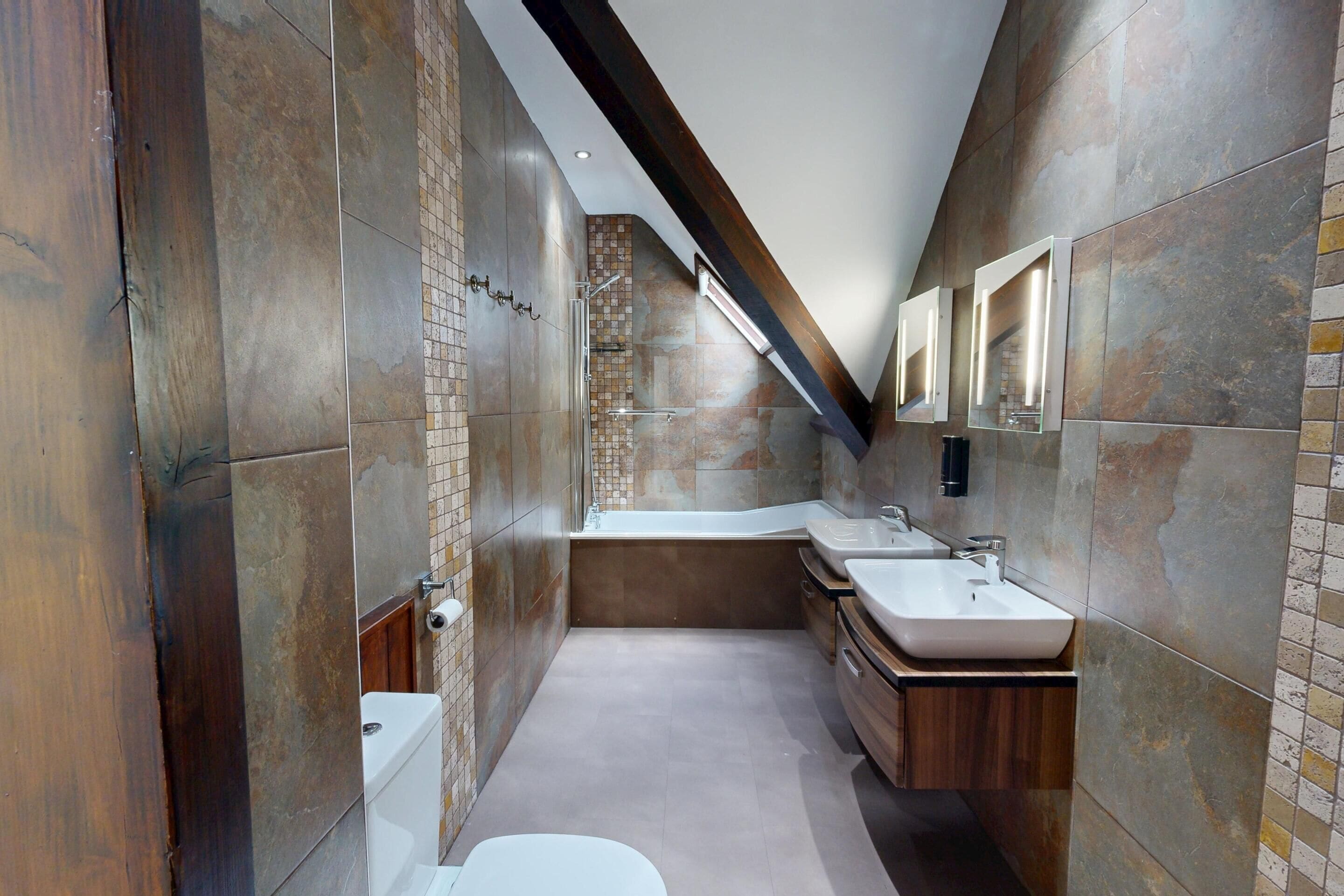 A modern bathroom with a walk-in shower, a bathtub, and a vanity with a sink.