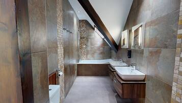 A modern bathroom with a walk-in shower, a bathtub, and a vanity with a sink.