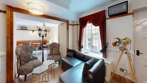 A room with a sofa, two patterned armchairs, a small table, and a lamp. - High Tor Hotel (Matlock)