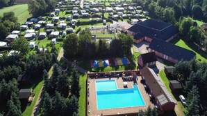 An aerial view of a campground with RVs, a swimming pool, and a large building. - 2 Person Holiday Park Home in Graested (Graested)