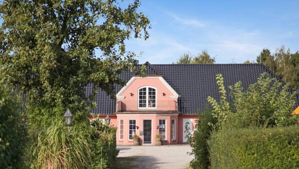 A two-story house with a dark tiled roof, a central entrance, and a gravel driveway. - 2 Person Holiday Park Home in Graested (Graested)