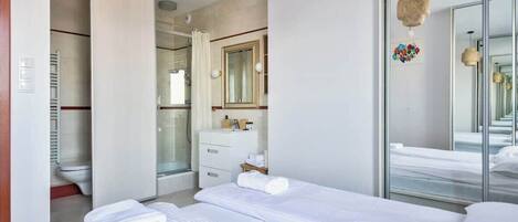Shower, hair dryer, towels, shampoo