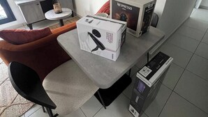A modern kitchen with a grey countertop, a Nespresso machine, and a Powerstrap coffee maker. - Elegant Appt - 1bdr/2p - Near Paris & La Defense (Suresnes)