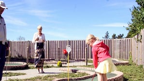 A miniature golf course with a wooden fence and a small pond. - 6 Person Holiday Park Home in Skagen (Skagen)