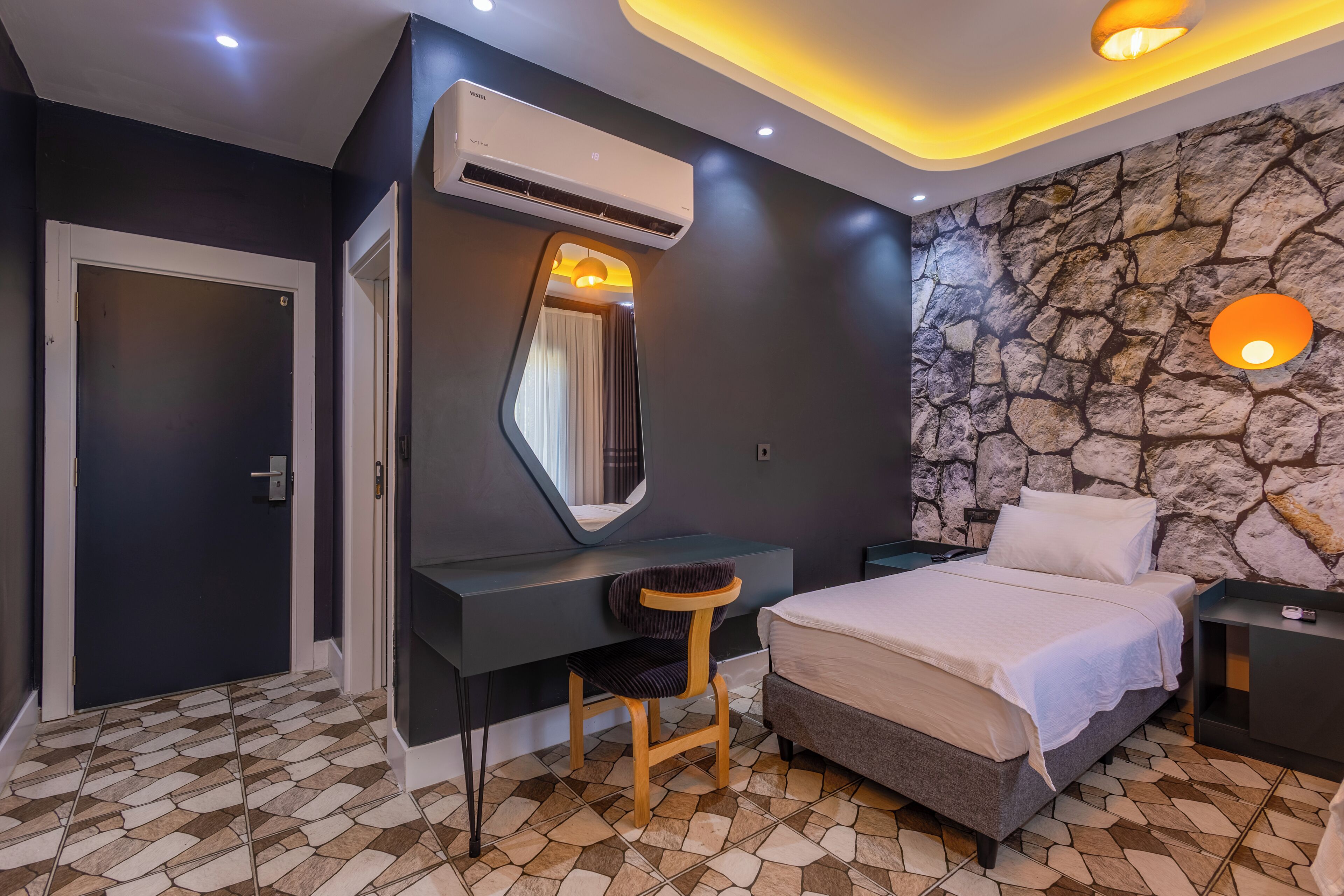 A modern bedroom with a bed, a desk, and a chair.