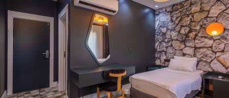 A modern bedroom with a bed, a desk, and a chair.