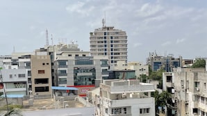 Un hôtel à plusieurs étages au design moderne, avec une enseigne bien visible indiquant « RCC Hotels Baniara Hills ».