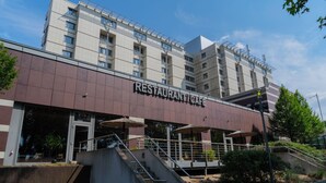 A multi-story building with a sign reading "RESTAURANT CAFÉ" on the ground floor.