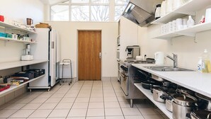A kitchen with white cabinets, a stainless steel range, and a large window. - 6 Person Holiday Park Home in Laeso (Læsø)