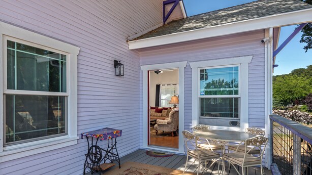 A porch with a table and chairs, a sewing machine, and a view into the house. - Fragrance free, 1930 2-bdrm Craftsman farmhouse on 3 acres at the edge of town (Santa Rosa)