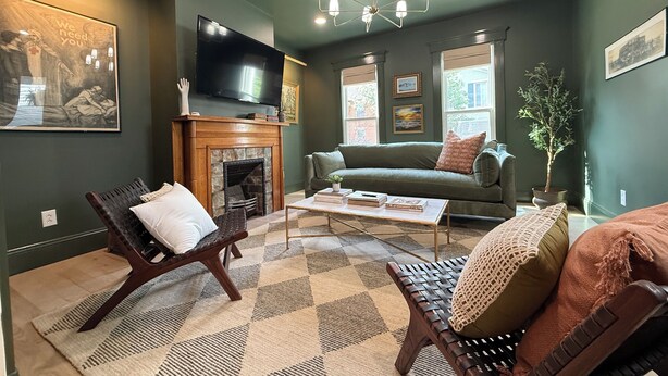 A living room with a fireplace, a sofa, a coffee table, and a television. - 3BR Luxury Oregon District Stay - Walk to Breweries, Dining + Free Parking (Dayton)