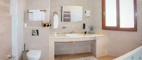 A modern bathroom with a toilet, sink, and bathtub.