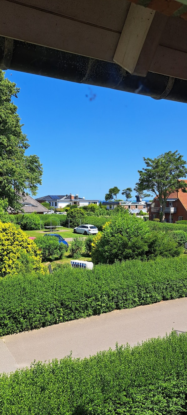 A residential area with houses, a road, and greenery.