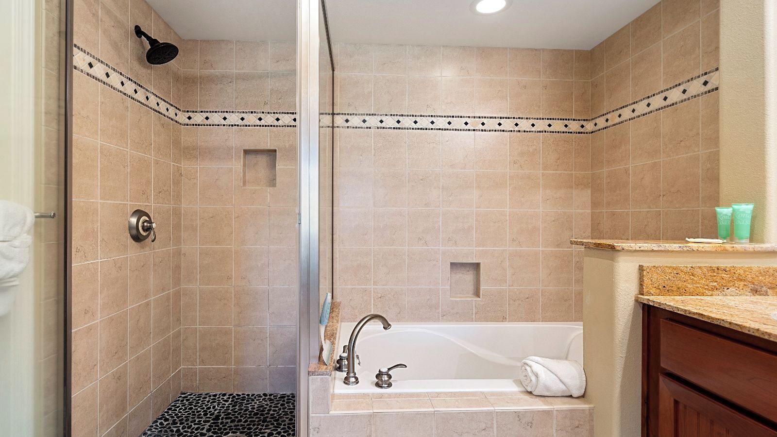 A bathroom with a shower, a bathtub, and a sink.