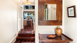 A wooden staircase leading to a second-floor area with a view of the outdoors.