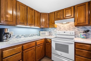 Condo, Multiple Beds, Lanai, Partial Ocean View (White Sands Village 210) | Private kitchen | Full-size fridge, microwave, oven, stovetop