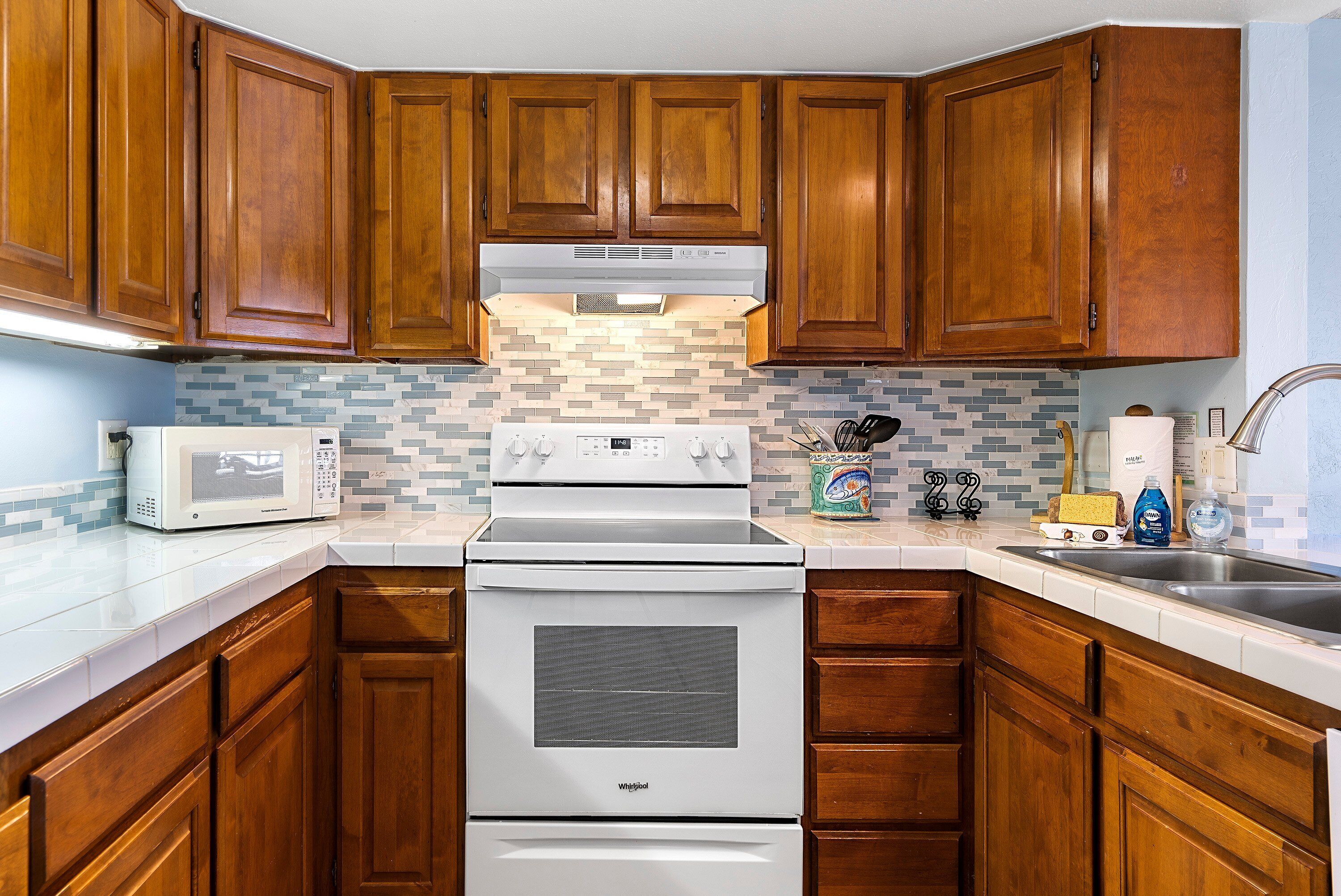 Condo, Multiple Beds, Lanai, Partial Ocean View (White Sands Village 210) | Private kitchen | Full-sized fridge, microwave, oven, stovetop