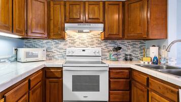 Condo, Multiple Beds, Lanai, Partial Ocean View (White Sands Village 210) | Private kitchen | Full-size fridge, microwave, oven, stovetop