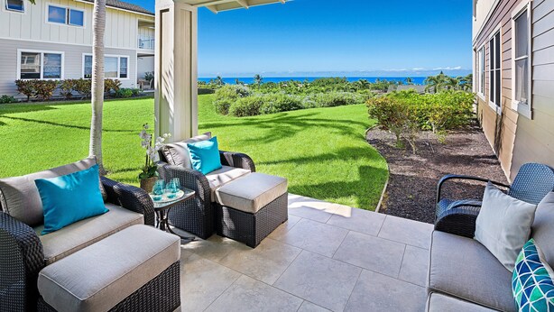 A covered patio with outdoor furniture, a view of the ocean, and a well-maintained lawn. - Ocean View - AC & Wifi - Walk to Beach & Shopping - Vrkcv (Kailua-Kona)