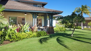 A two-story house with a covered porch, a stone pillar, and a well-maintained lawn. - Concierge Included - AC - Wifi - Mauna Lani Beach Access - Vrkcv (Kamuela)