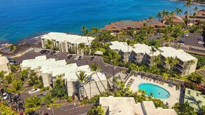 A resort with a pool, multiple buildings, and a view of the ocean. - Oceanview Kona Condo - Pool, Lanai, Walk to Town - Vrkcv (Kailua-Kona)