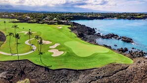 A golf course with a view of the ocean and a volcanic landscape. - Luxury Golfside Condo w/ Ocean Views, Central AC & Beach Club - Vrkcv (Kamuela)