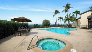 A pool area with a hot tub, lounge chairs, and a view of the ocean. - No Stairs - AC - Fantastic Ocean & Golf Course Views! -vrkcv (Kailua-Kona)