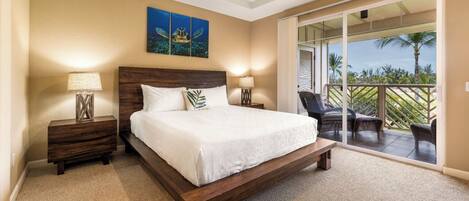 A bedroom with a large bed, two bedside tables, a ceiling light, and a view of a balcony with outdoor furniture.