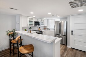 Condo, Multiple Beds, Lanai, Partial Ocean View (White Sands Village 220) | Private kitchen | Dining tables