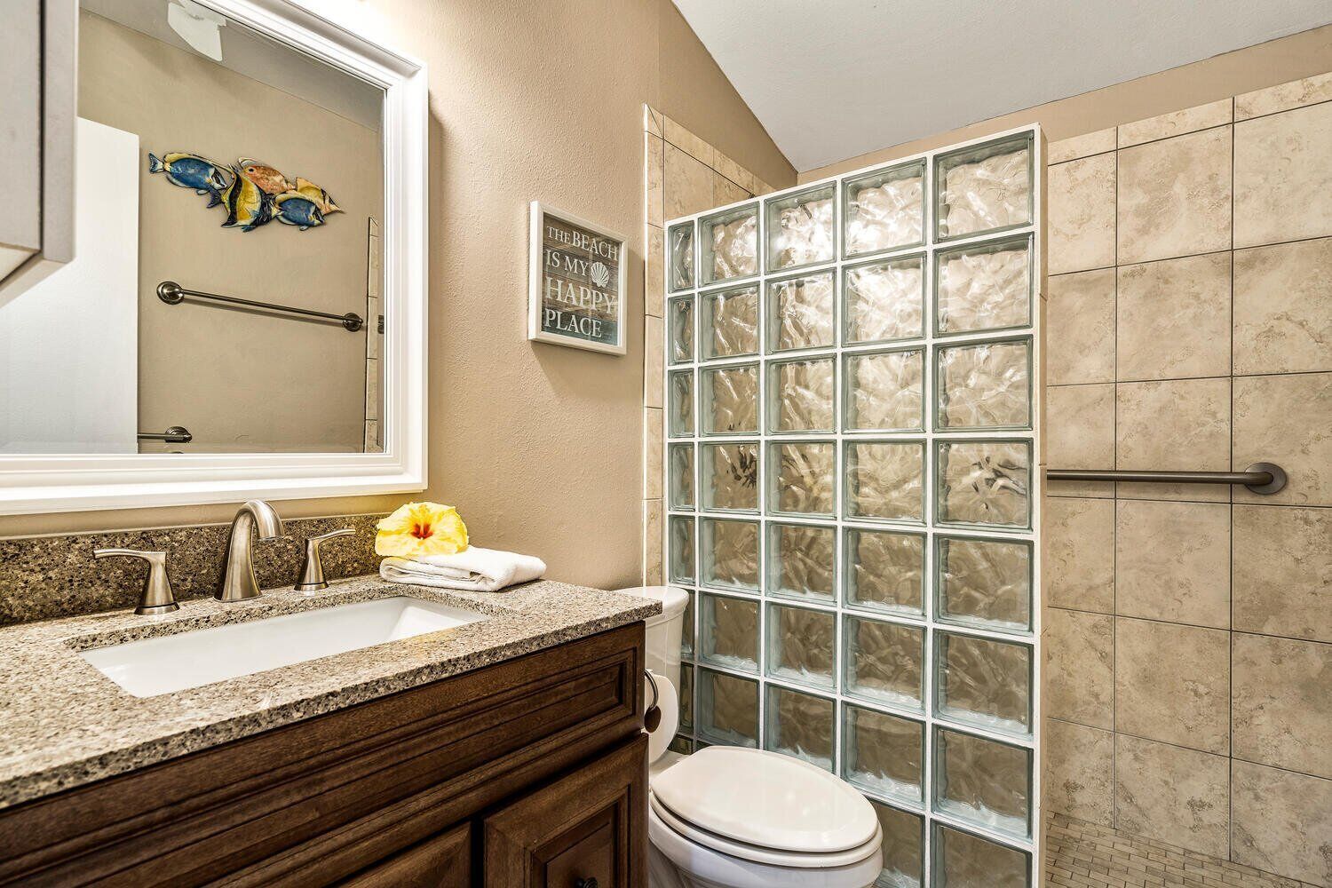 A bathroom with a sink, mirror, and toilet.