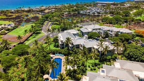 A resort with multiple buildings, a swimming pool, and a view of the ocean. - Ground Floor Corner Unit - Vrkcv (Waikoloa)