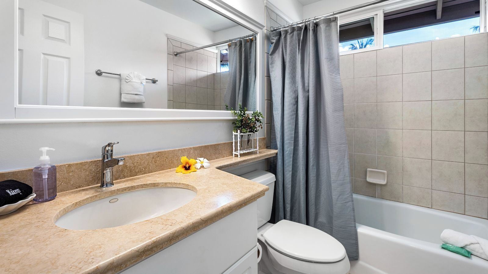 A bathroom with a sink, toilet, and bathtub.
