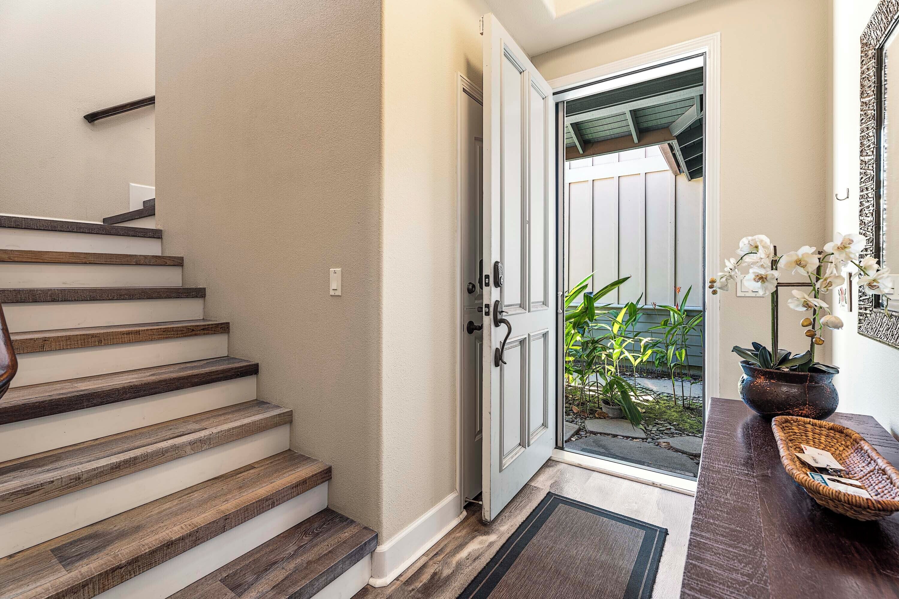 A staircase with wooden steps leading to a white door.