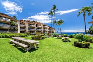A resort with a pool area, outdoor seating, and a view of the ocean. - Spectacular Ocean Views - Close to Town - Free Concierge - Vrkcv (Kailua-Kona)