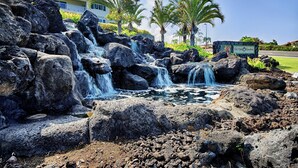 A natural rock waterfall with a sign indicating 'Na Hale O Keauhou'. - Concierge Included - Ocean View - Walk to Beach - Central AC - Vrkcv (Kailua-Kona)